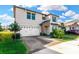 Two-story house with a three-car garage, landscaping and paver driveway at 21680 Violet Periwinkle Dr, Land O Lakes, FL 34637