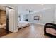 Spacious bedroom with wood-look floors, large window, and en-suite bathroom at 2790 Pinellas Point S Dr, St Petersburg, FL 33712
