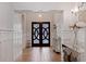 Elegant entryway with double doors and a stylish console table at 2790 Pinellas Point S Dr, St Petersburg, FL 33712