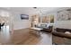 Open living area with hardwood floors, a modern sofa, and large windows at 2790 Pinellas Point S Dr, St Petersburg, FL 33712