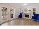 Living room features fireplace, hardwood floors, and French doors leading to patio at 2790 Pinellas Point S Dr, St Petersburg, FL 33712