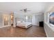 Large main bedroom with wood-look floors and en-suite bathroom at 2790 Pinellas Point S Dr, St Petersburg, FL 33712