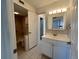 Clean bathroom with shower/tub combo, vanity, and linen closet at 2991 Flint S Dr # 77-D, Clearwater, FL 33759