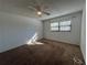Bright bedroom with neutral carpeting, a ceiling fan, and a window with natural light at 2991 Flint S Dr # 77-D, Clearwater, FL 33759