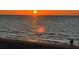 Romantic beach sunset with couple strolling along shore at 3100 Gulf Blvd # 424, Belleair Beach, FL 33786