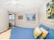Main bedroom with ocean view, king-size bed, and access to balcony at 3100 Gulf Blvd # 424, Belleair Beach, FL 33786