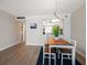 Dining area features a wood table and white chairs at 3100 Gulf Blvd # 424, Belleair Beach, FL 33786