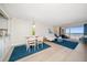 Open concept dining area with ocean view and white table at 3100 Gulf Blvd # 424, Belleair Beach, FL 33786