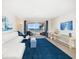Bright living room with ocean view, comfy sectional sofa, and blue rug at 3100 Gulf Blvd # 424, Belleair Beach, FL 33786