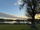Peaceful backyard view, overlooking lake at sunset at 3922 Lake Joyce Dr, Land O Lakes, FL 34639
