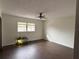 Bright bedroom featuring laminate wood floors and a ceiling fan at 3922 Lake Joyce Dr, Land O Lakes, FL 34639