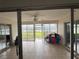 Spacious Florida room with tiled floors and lake view at 3922 Lake Joyce Dr, Land O Lakes, FL 34639