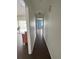 Long hallway with dark laminate flooring at 3922 Lake Joyce Dr, Land O Lakes, FL 34639