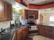 Kitchen with granite countertops and wooden cabinets at 3922 Lake Joyce Dr, Land O Lakes, FL 34639