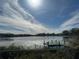 Peaceful lake view with a wooden dock at 3922 Lake Joyce Dr, Land O Lakes, FL 34639
