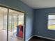 Living room with sliding doors to a screened porch at 3922 Lake Joyce Dr, Land O Lakes, FL 34639