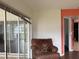 Living area with leather chair and sliding doors at 3922 Lake Joyce Dr, Land O Lakes, FL 34639