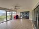 Screened porch with tiled floor and lake view at 3922 Lake Joyce Dr, Land O Lakes, FL 34639