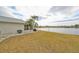 Exterior view of a home with a large backyard overlooking a tranquil lake with scenic water views at 407 Blackhawk Cir, Sun City Center, FL 33573