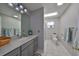 Well-lit bathroom with a vanity and a separate shower area at 407 Blackhawk Cir, Sun City Center, FL 33573