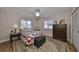 Cozy bedroom with charming decor, a decorative rug and wood flooring at 407 Blackhawk Cir, Sun City Center, FL 33573