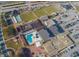 Aerial view of community amenities including pool, sports fields, clubhouse, and ample parking at 407 Blackhawk Cir, Sun City Center, FL 33573