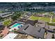 Aerial view of a community center featuring a large outdoor pool with ample parking and recreation areas at 407 Blackhawk Cir, Sun City Center, FL 33573