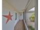 Covered front porch with decorative details and tiled floor at 407 Blackhawk Cir, Sun City Center, FL 33573