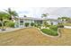 Landscaped front yard featuring a well-maintained lawn and trimmed hedges at 407 Blackhawk Cir, Sun City Center, FL 33573
