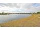 Scenic lake view showcasing waterfront living and community amenities with a clear, cloudy sky at 407 Blackhawk Cir, Sun City Center, FL 33573