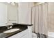 Cozy bathroom featuring black granite countertops, a large mirror, and a shower/tub combination at 515 Gilman N Ct, St Petersburg, FL 33716