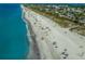 Aerial view of a crowded beach with turquoise water at 6119 Gnarled Oak Ln, Englewood, FL 34223