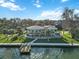 Waterfront home with circular design, private dock, and lush landscaping at 6119 Gnarled Oak Ln, Englewood, FL 34223