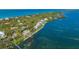 Bird's-eye view of waterfront property and surrounding neighborhood at 6119 Gnarled Oak Ln, Englewood, FL 34223