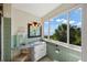 Bathroom with a vanity, large window, and view at 6119 Gnarled Oak Ln, Englewood, FL 34223