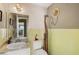 Small bathroom with granite vanity, tiled walls, and a toilet at 6119 Gnarled Oak Ln, Englewood, FL 34223