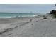 Peaceful beach scene with people fishing and kitesurfing at 6119 Gnarled Oak Ln, Englewood, FL 34223