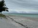 Serene beach view with calm waves at 6119 Gnarled Oak Ln, Englewood, FL 34223