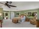 Bedroom with king-size bed, ceiling fan, and access to deck at 6119 Gnarled Oak Ln, Englewood, FL 34223