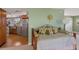 Guest bedroom with daybed and view into kitchen at 6119 Gnarled Oak Ln, Englewood, FL 34223