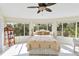 Bright bedroom with a queen-size bed and large windows at 6119 Gnarled Oak Ln, Englewood, FL 34223