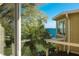 Deck overlooking the water with partial view of house at 6119 Gnarled Oak Ln, Englewood, FL 34223