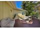 Deck with a wicker chair and steps leading down at 6119 Gnarled Oak Ln, Englewood, FL 34223