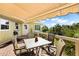 Deck with dining table, chairs and awning at 6119 Gnarled Oak Ln, Englewood, FL 34223