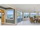 Spacious dining area with large windows offering stunning water views at 6119 Gnarled Oak Ln, Englewood, FL 34223