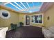 Covered patio with pergola, wicker furniture, and waterfront view at 6119 Gnarled Oak Ln, Englewood, FL 34223