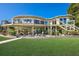 Elevated home with a large deck and landscaped yard at 6119 Gnarled Oak Ln, Englewood, FL 34223