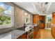 Modern kitchen with granite counters and stainless steel appliances at 6119 Gnarled Oak Ln, Englewood, FL 34223