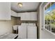 Laundry room with washer, dryer, cabinets, and a sink at 6119 Gnarled Oak Ln, Englewood, FL 34223