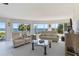 Spacious living room with comfortable seating and stunning water views at 6119 Gnarled Oak Ln, Englewood, FL 34223